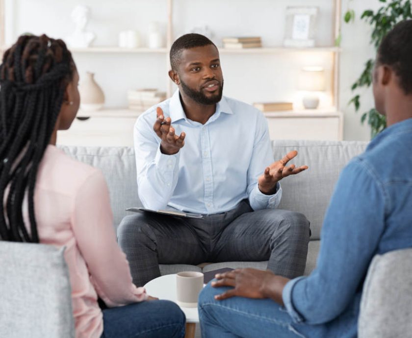 Family Psychotherapy. African American Couple Listening To Counselor's Advices During Therapy Session